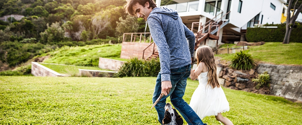 Holmes Place | Dad and daughter playing with dog outside