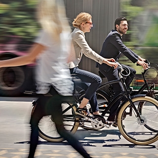 Holmes Place | Man and Woman riding bike in the street
