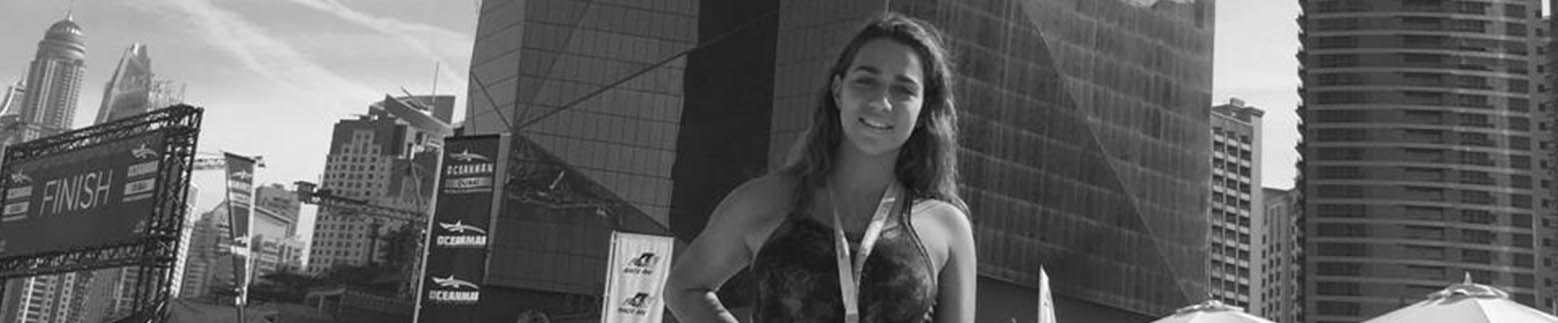 Holmes Place | young woman smiling in swimming race