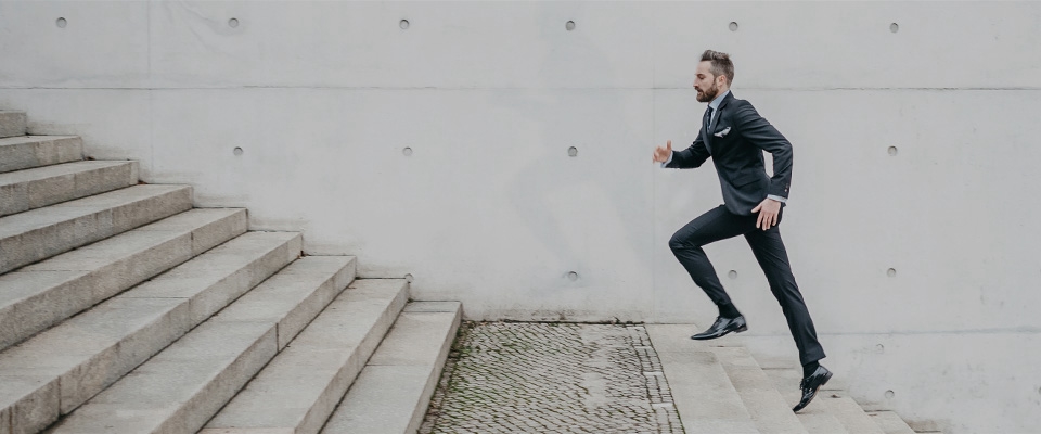 Holmes Place | Man in a Suit Climbing Stairs