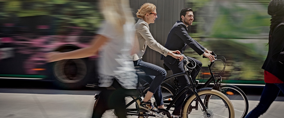 Holmes Place | Man and Woman riding bike in the street