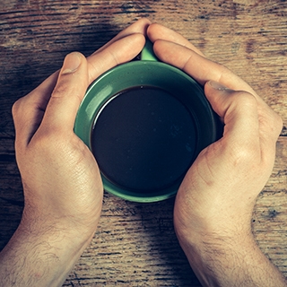 Holmes Place | Holding cup of coffee
