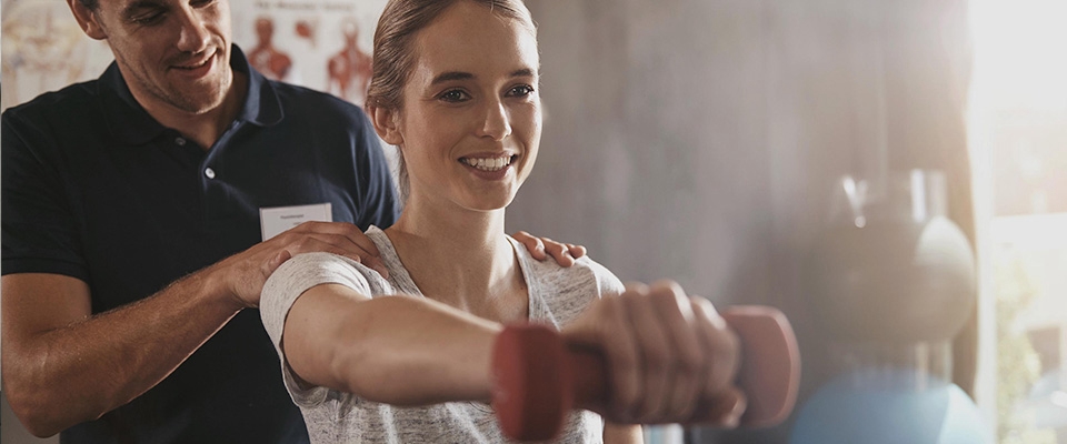 Holmes Place | Woman Exercising with Personal Trainer